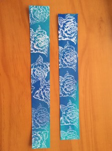 rose stamp print white acrylic on blue paper